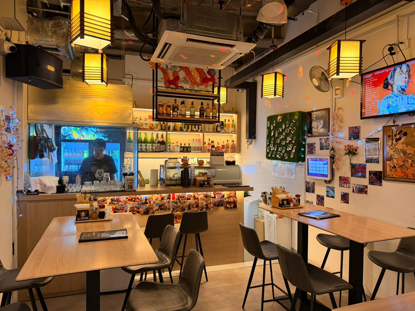 Interior of Izakaya Tamako with warm lantern lighting and bar counter